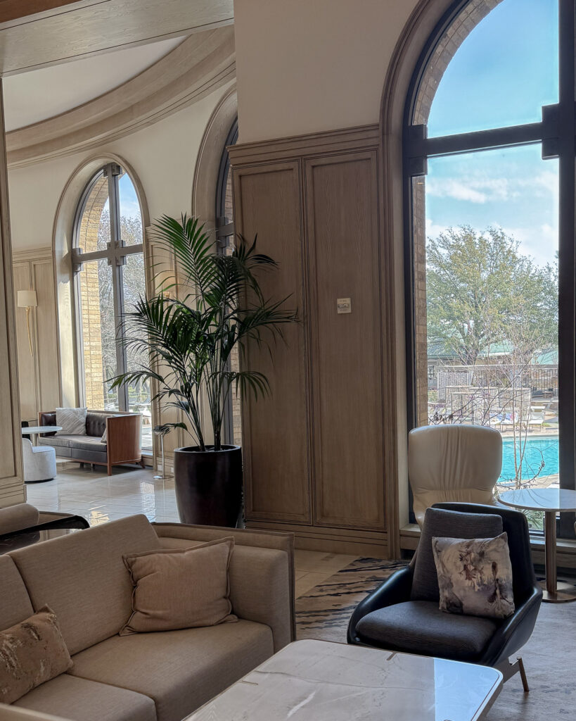 Hotel lobby with arched windows and pool view