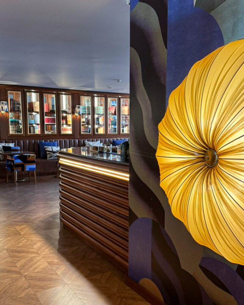 A dome light  brightens the walkway to a modern lobby and reservation desk