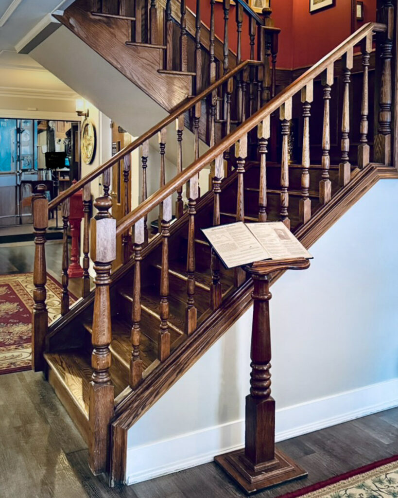 Traditional wood staircase with carved balusters in lodge interior